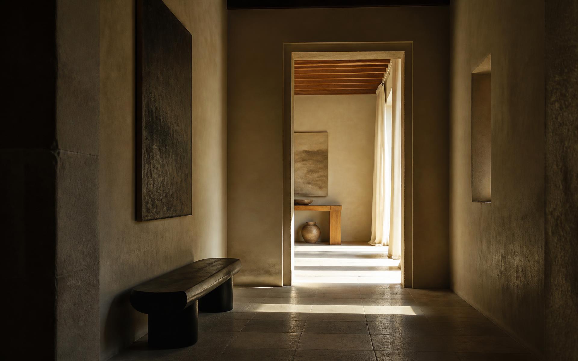 Sunlit hallway opening into a warm neutral interior
