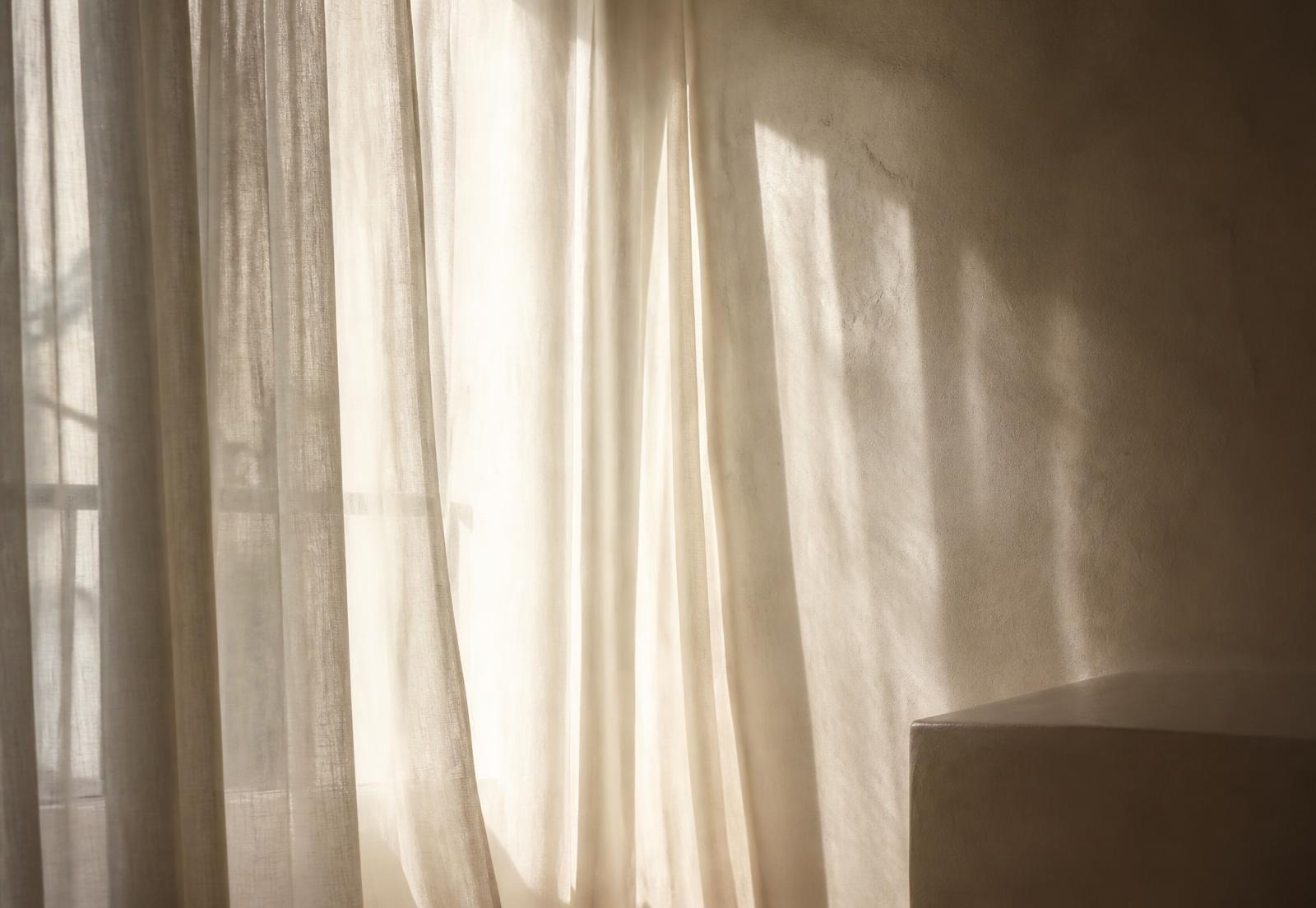 Sheer curtains filtering afternoon light