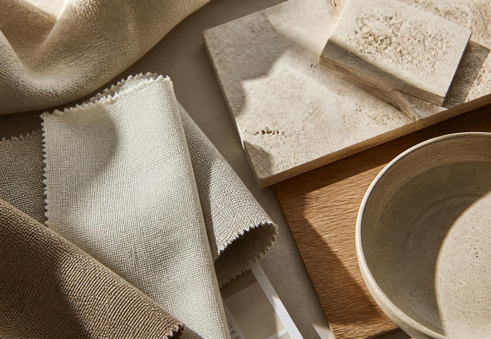 Linen swatches, travertine samples and oak veneer in warm light